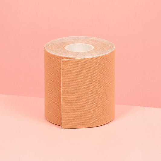 Boob tape in Nude colour is displayed on a pink table, highlighting its appearance.