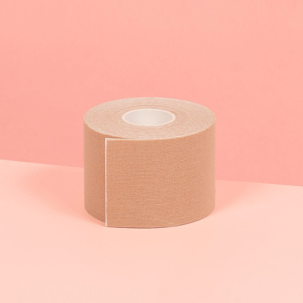 5 cm nude double sided boob tape is showcased on a pink table.