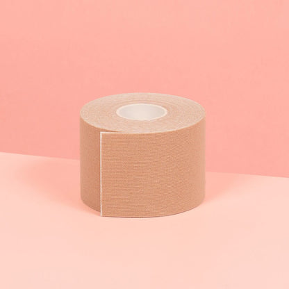 5 cm nude double sided boob tape is showcased on a pink table.