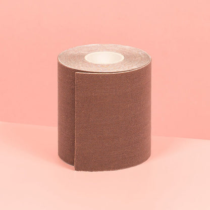 7 cm chocolate double sided boob tape is showcased on a pink table.