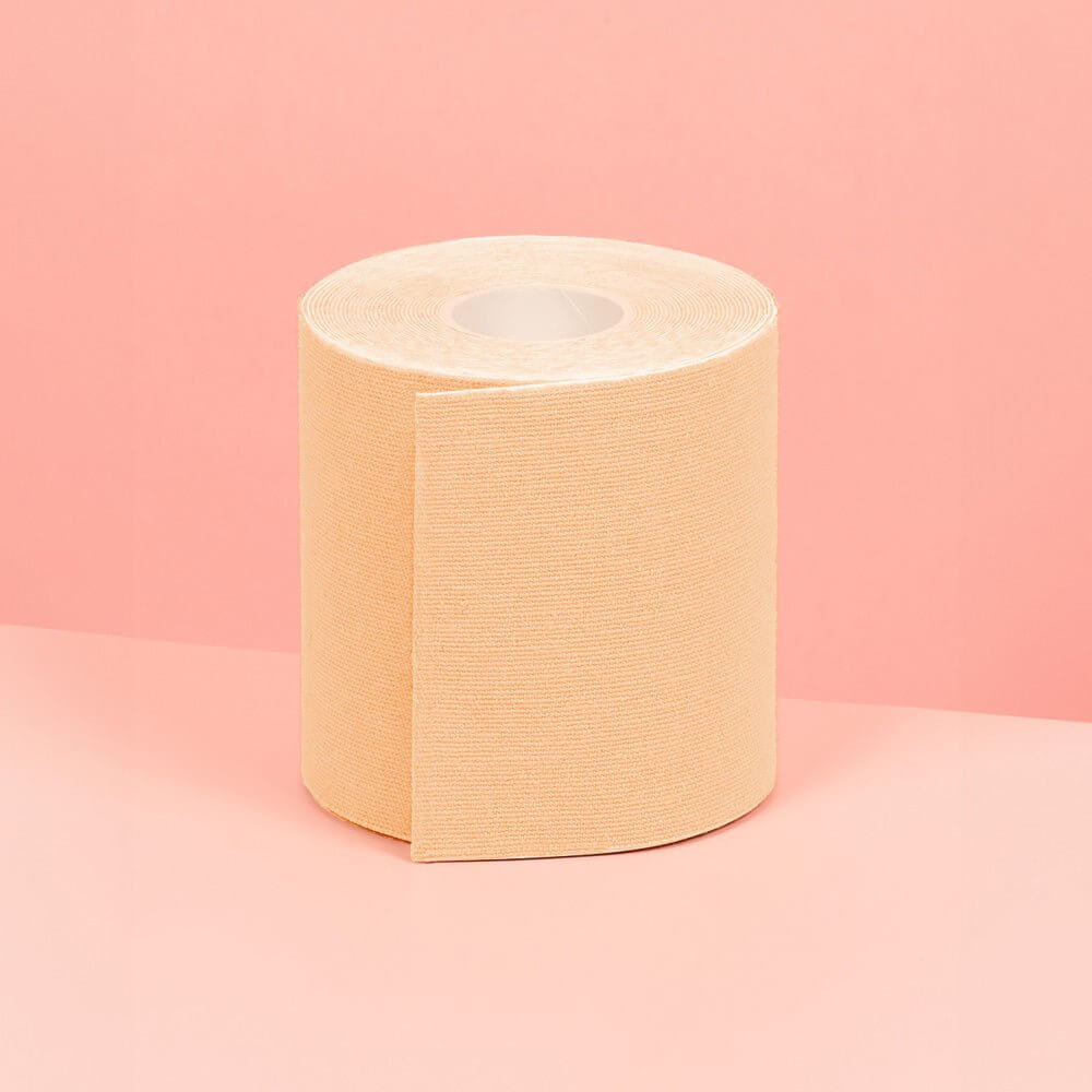 7.5 cm double sided breast beige tape is showcased on a pink table.