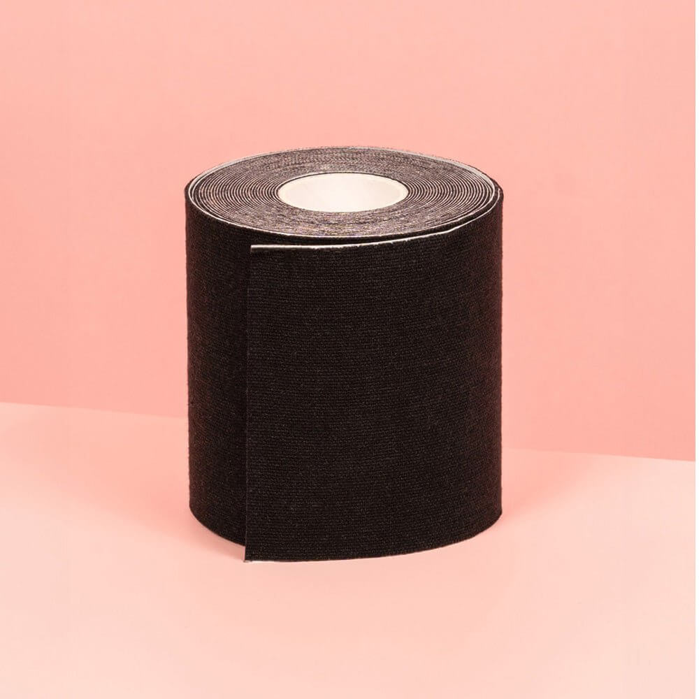 A larger 7.5 cm black boob tape is displayed against a pink background.