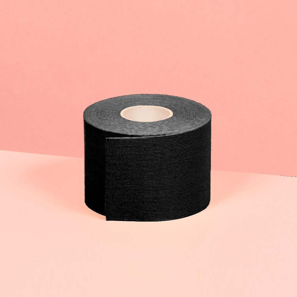 5 cm black boob tape is shown in the picture in front of a pink background.