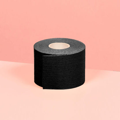5 cm black boob tape is shown in the picture in front of a pink background.