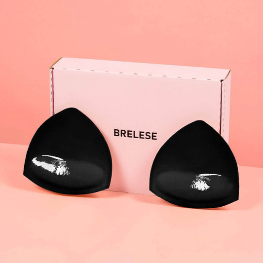 Discreet Sticky Bra Inserts in Black colour in front of the pink box with the logo Brelese